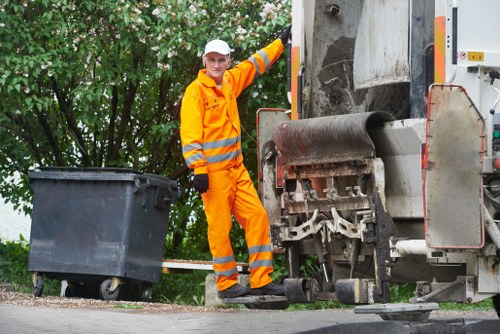 Operative sorting waste and inspecting for hazards